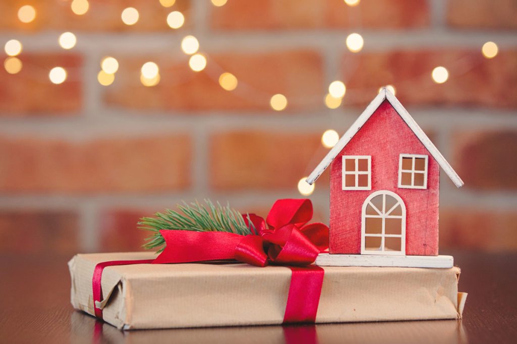 Model house and gift wrapped present image for are there tax implications for making gifts blog