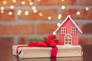 Model house and gift wrapped present image for are there tax implications for making gifts blog