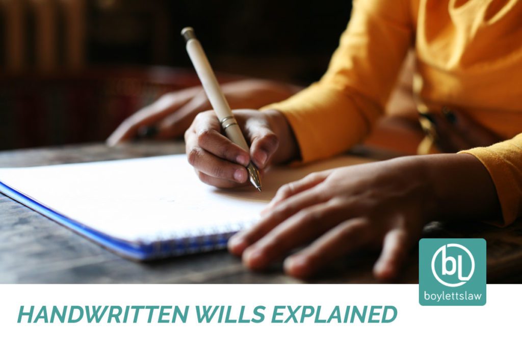 Person writing on a notepad image for handwritten wills explained blog
