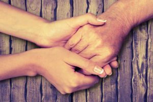Two hands holding another person's hand image for is it time to think about making an LPA blog