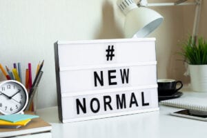 #NewNormal sign on a desk image for COVID 19: making a Will blog