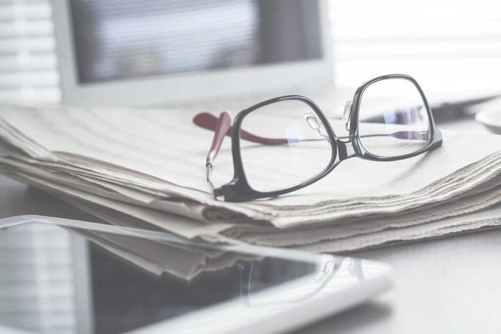 Pair of glasses on a newspaper image for Boyletts Law celebrates 6 months since opening during unprecedented year news item