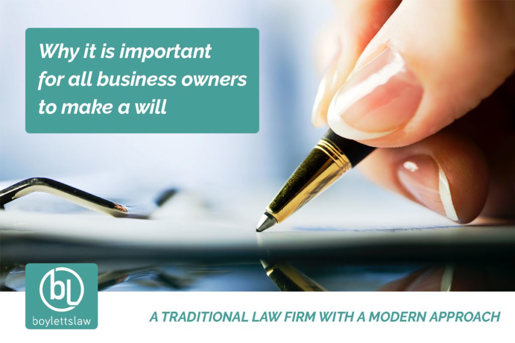 Woman holding a pen signing a document image for why business owners should make a will blog