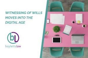 Image of a tablet and a laptop on pink meeting room table for blog about witnessing of wills moves into the digital age