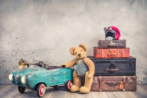 Teddy bear with luggage and a car image for 5 reasons parents should make a will
